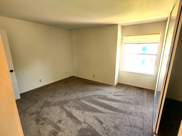 Primary bedroom, as seen from the adjoining bathroom door.