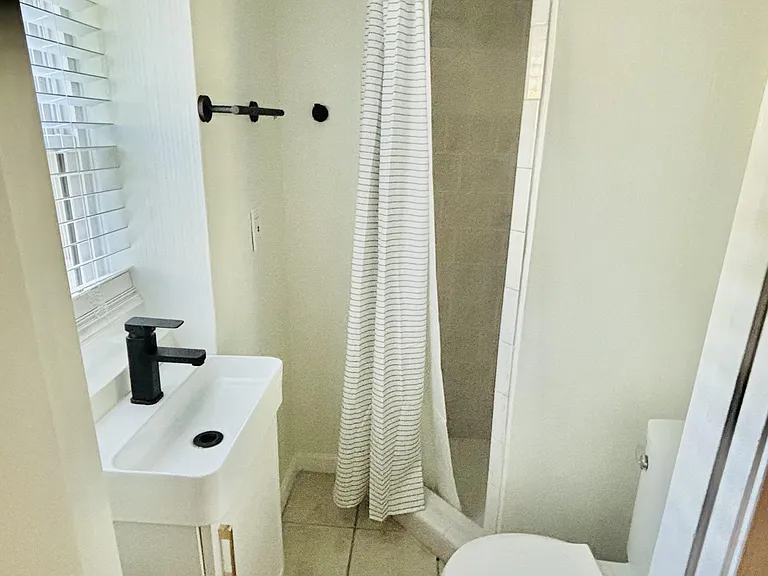 Shared downstairs hallway bathroom with stand up shower