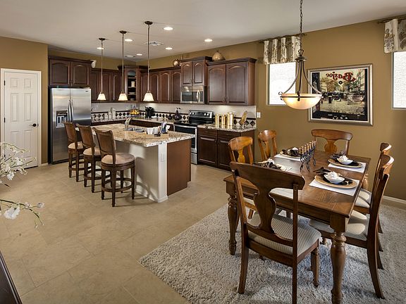 The open kitchen flows into a dining nook, both of