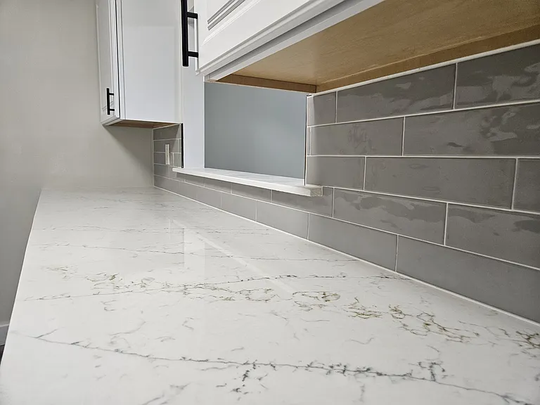 Designer tile backsplash and quartz countertops