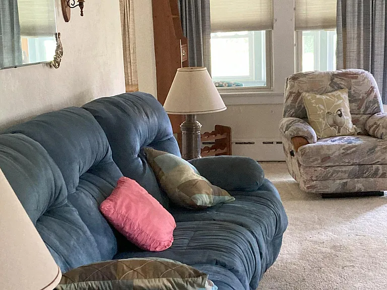living room facing side of house Windows in the front lead to porch.