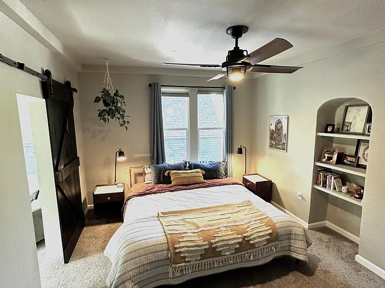2nd master bedroom on 2nd floor with adjoining full bathroom, custom large walk-in closet, ceiling fan, built-in bookcase, and sunroom.