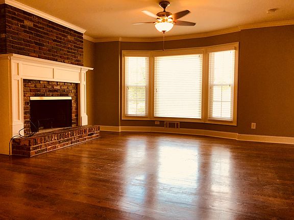 View from open kitchen. Cozy wood burning fireplace and bay windows for loads of light.