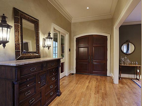 Impressive entry opens to study & formal dining.Hardwoods in all rooms except baths & laundry which 