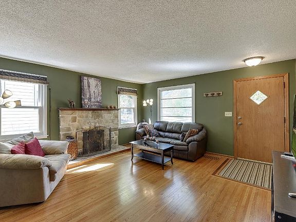 Front entrance into the living room - notice the stone wood-burning fireplace!