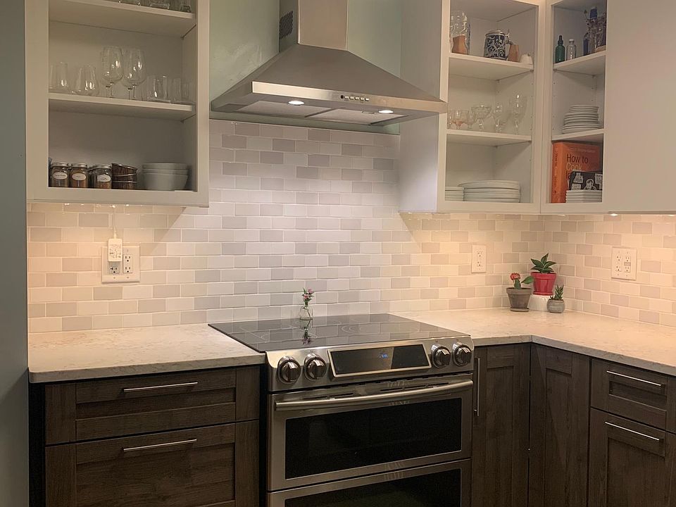 Recently renovated kitchen. Tile floor, open shelving, and quartz countertops.