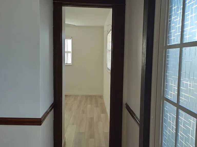 Front doorway looking into bedroom 2 / office.