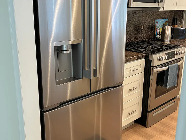New LG refrigerator with water and ice dispenser.