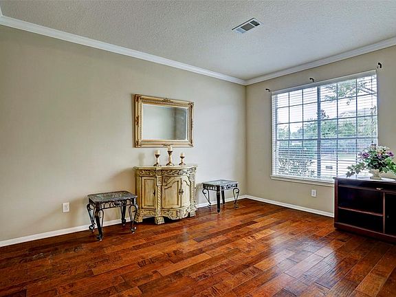 Formal living room that can function easily as a study. Wooden floor and crown moulding throughout!