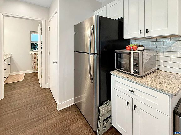 Stackable washer and dryer are behind the closed door in the picture.