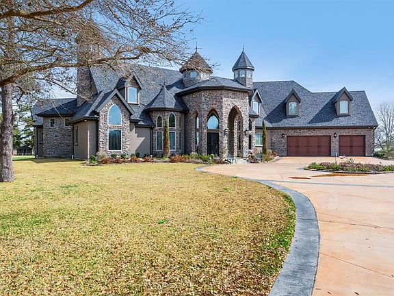 Luxury! This striking entry features a circle drive and 3 car finished garage, large enough for that pickup and a couple of cars. Look out across the front pond and enjoy watching the ducks and other fowl playing. It's time to relax.