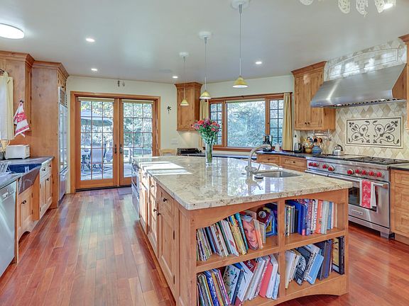 View from great space into kitchen. Patio behind double doors.