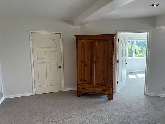 Armoire and door to shared laundry (Living room)
