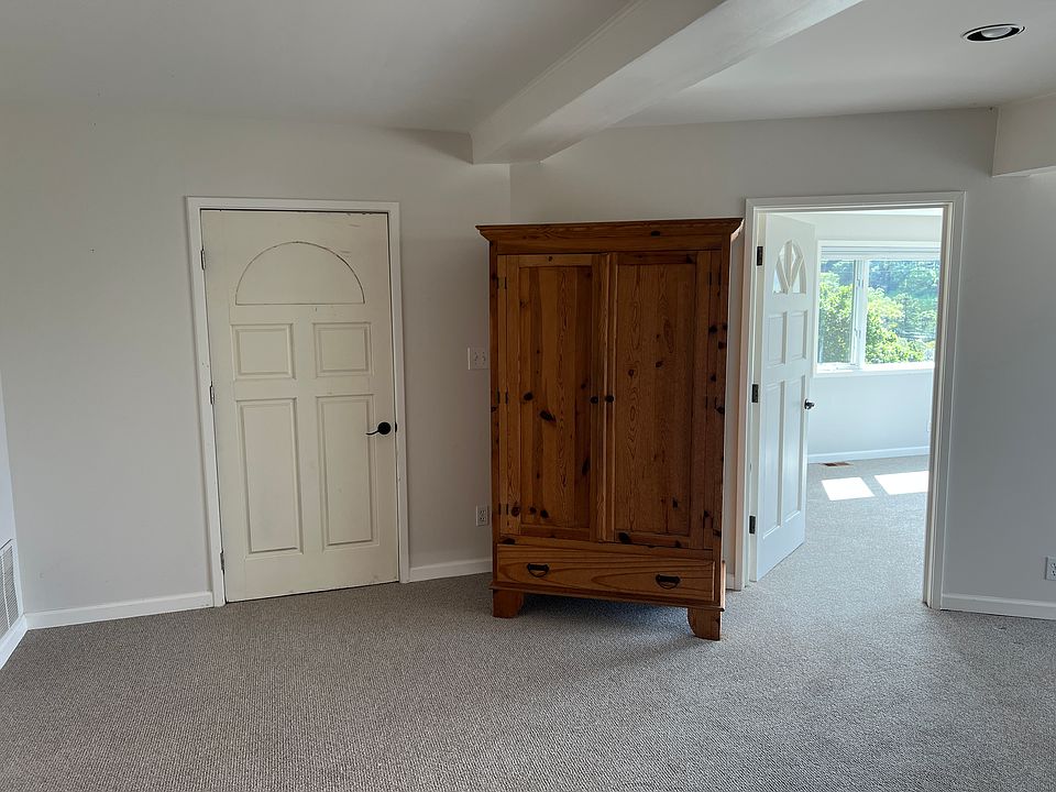 Armoire and door to shared laundry (Living room)