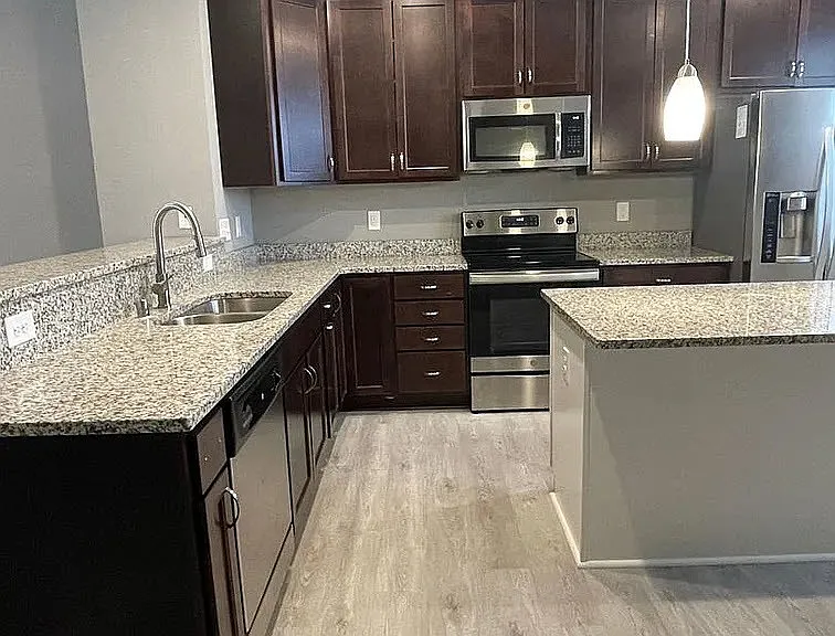 Elevate your lifestyle at LS Capital Group with this stunning kitchen featuring modern appliances and sleek finishes. Enjoy spacious countertops and a stylish design perfect for both cooking and entertaining. Explore your new home today!