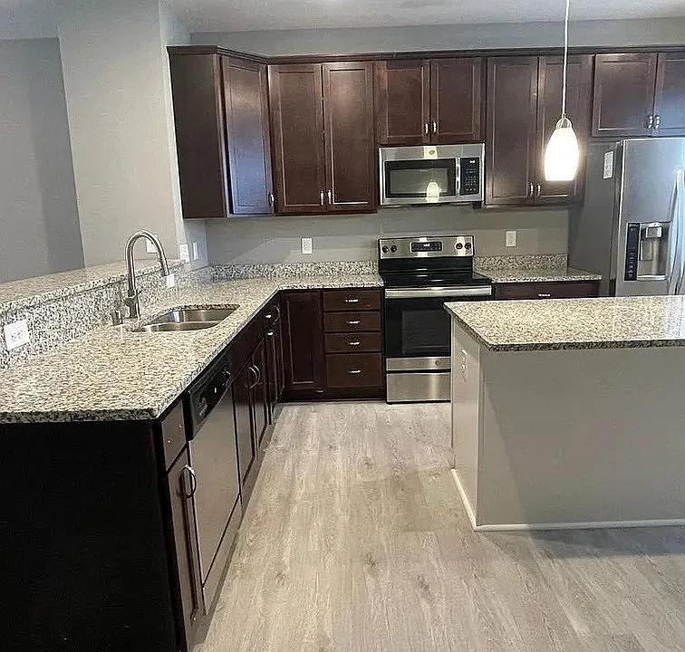 Elevate your lifestyle at LS Capital Group with this stunning kitchen featuring modern appliances and sleek finishes. Enjoy spacious countertops and a stylish design perfect for both cooking and entertaining. Explore your new home today!