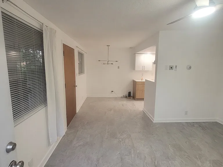 View from back door into living room toward dining space and kitchen.