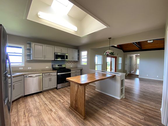 Kitchen with skylight and mango wood bar