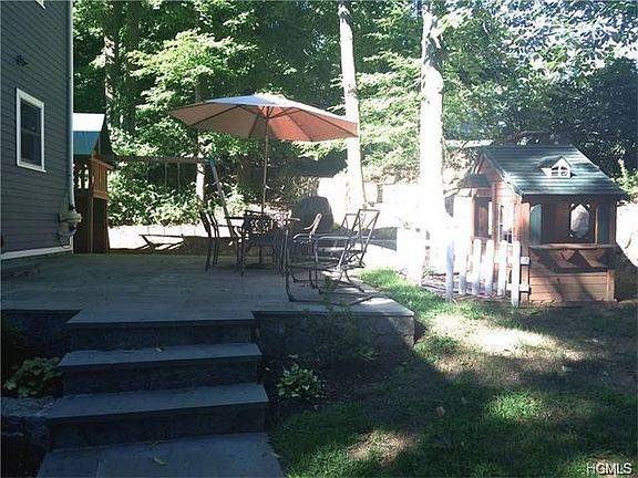 Sliding glass doors from the kitchen lead you to a private back yard, stone patio and play sets for 