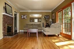 LIVING RM WITH HARDWOOD FLOORING,FIREPLACE, AND SLIDERS TO DECK