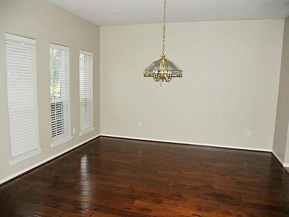 Formal Dining With Wood Floors & High Ceilings.