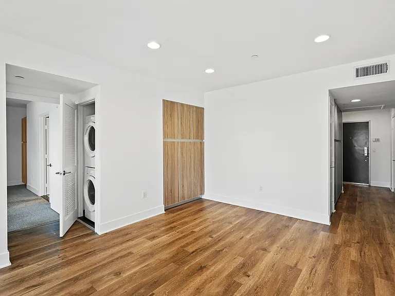 Living Room Space with Cabinet Storage and In-Suite Washer & Dryer