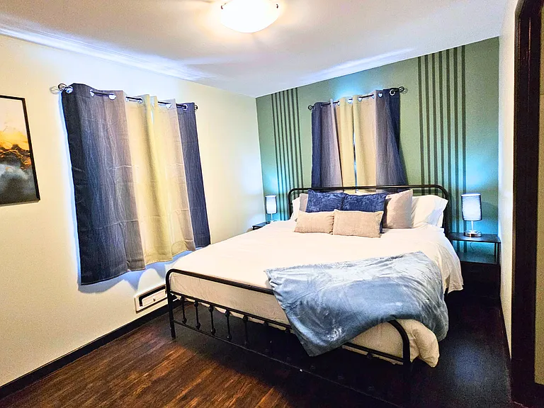 Main floor bedroom with king bed and roku TV