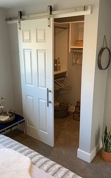 Walk-in closet with built ins and barn door.