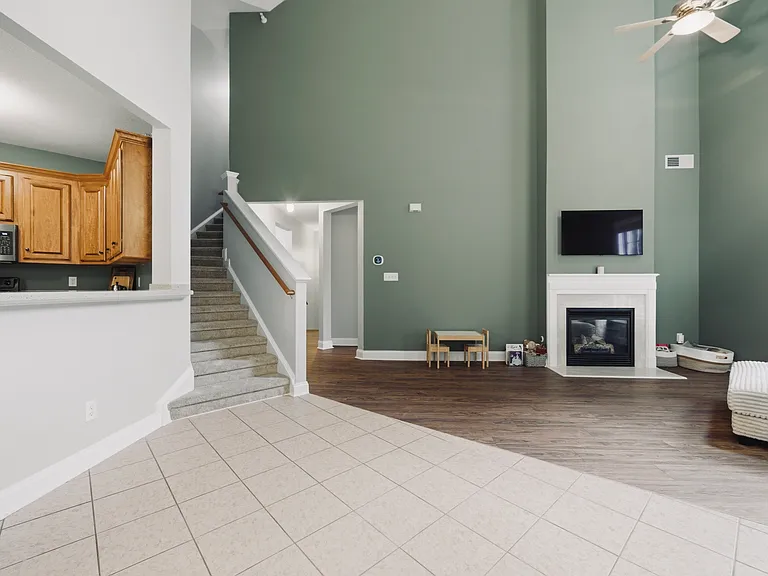 Open living and dining area with stairs to third story