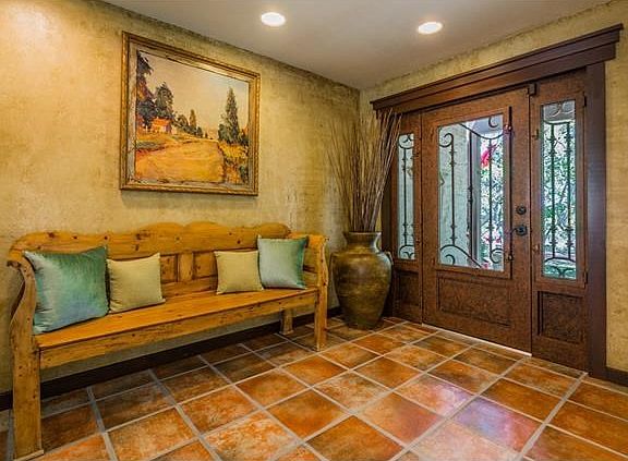 Cantera style door at the entry speaks to the quality throughout this house.