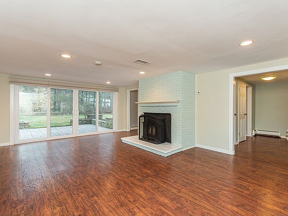 Ground level family room w/ sliders to paver patio in backyard