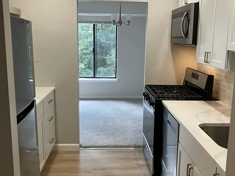 Wide kitchen space with plenty of kitchen cabinets.
