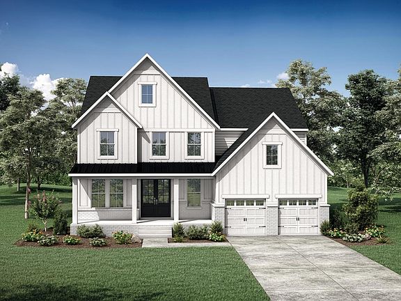 brick and board and batten house with front porch