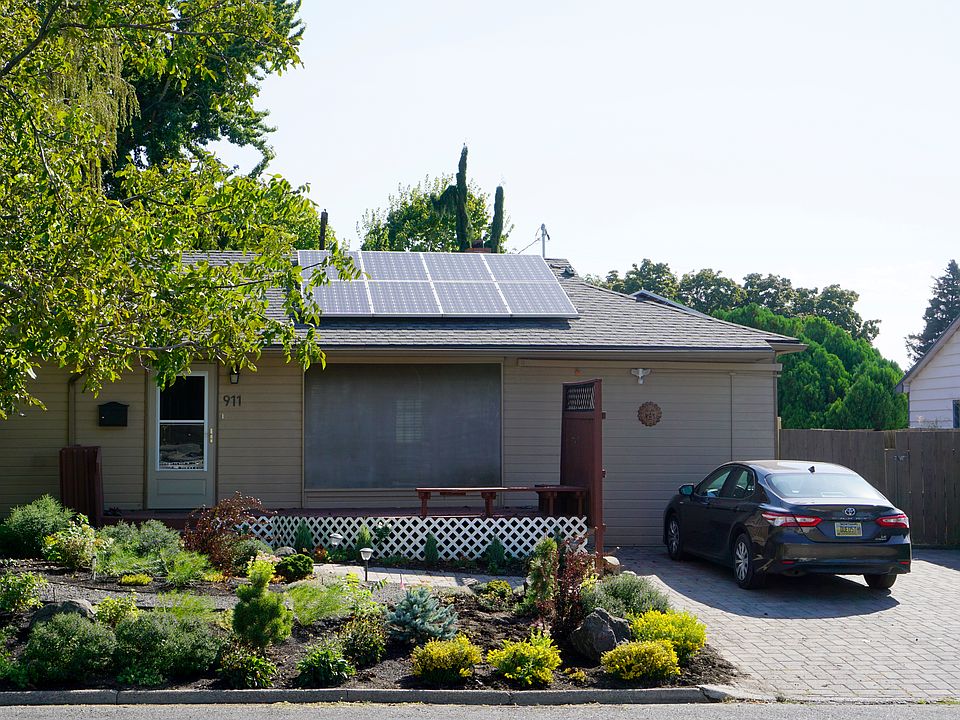 Front yard with landscaping two-car driveway.