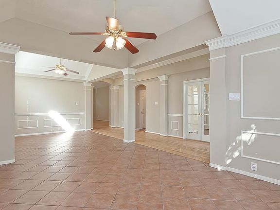 Providing so many furniture placement options and offset by decorative columns, this is a view of the formal living and dining rooms.