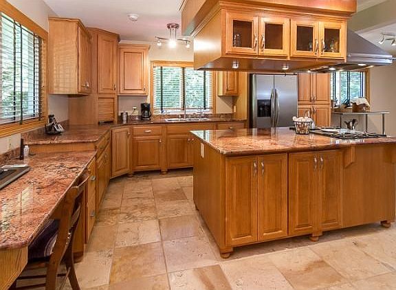 Step inside the front door onto the entryway and to the left you will see the kitchen, with custom c