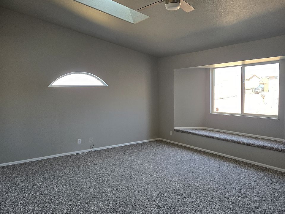 Living room with window seat and skylight