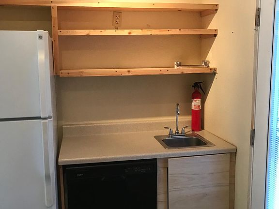 Kitchen looking West. Has dishwasher.