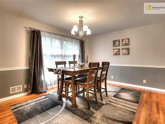 The dining room has large windows for natural light and original hardwood floors in pristine condition. The room has recently been painted and has a new updated light fixture.