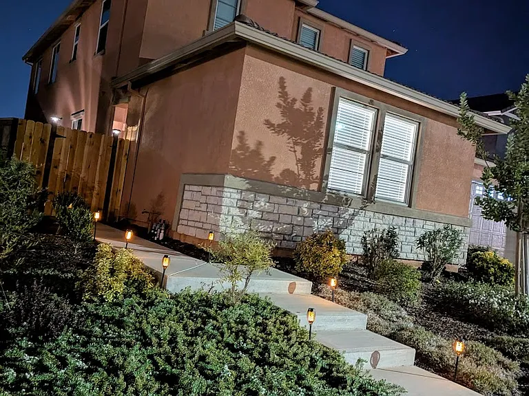 Enjoy the convenience and security of your own private, well-lit entrance walkway. This dedicated path offers easy access while creating an inviting ambiance with beautiful landscape lighting. Your own personal, peaceful welcome home.