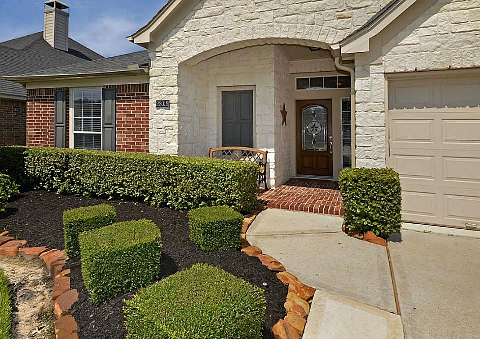 The beautiful stone and brick exterior, along with the covered front porch, really make this home shine!!