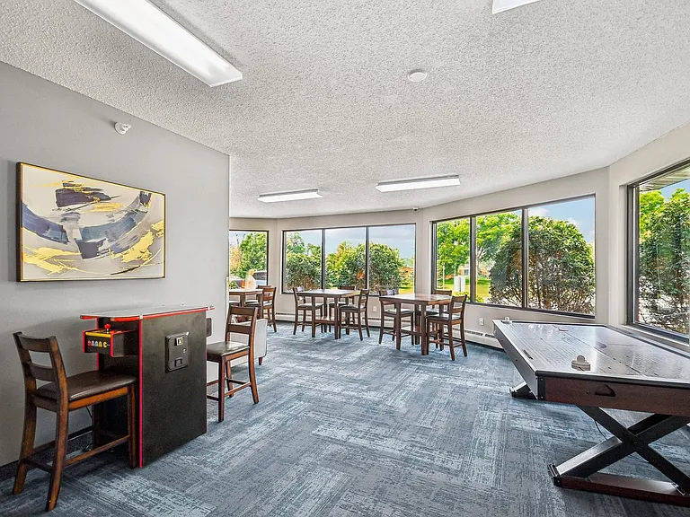 Step into the inviting community lounge at Mill Pond Apartments, where modern design meets comfort. Natural light floods the space, creating an ideal atmosphere for relaxation and socializing. Schedule your visit today to see it for yourself!
