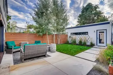 The structure in white is the 2-car garage, accessible via the door in the picture