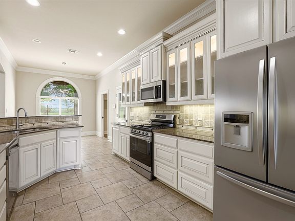Love the wall of glass front cabinets with adjustable shelves