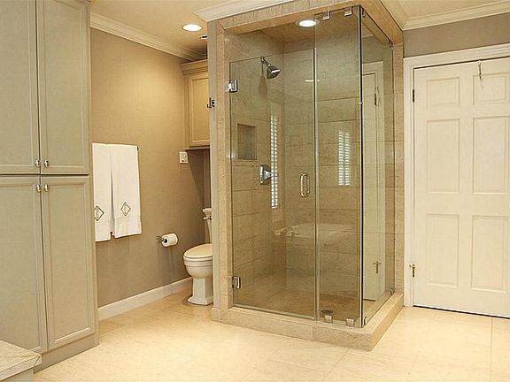 Beautifully updated master bath with glass shower and separate tub and double sinks.