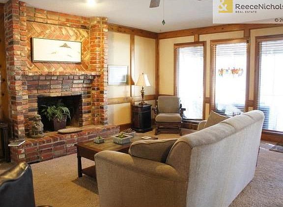 Large brick fireplace in family room with access to the screened-in porch