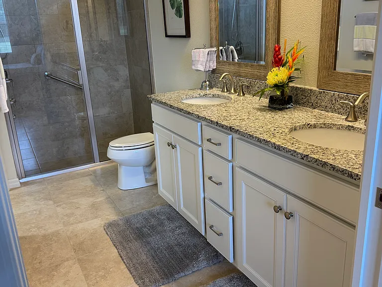 Primary bathroom with double granite vanities
