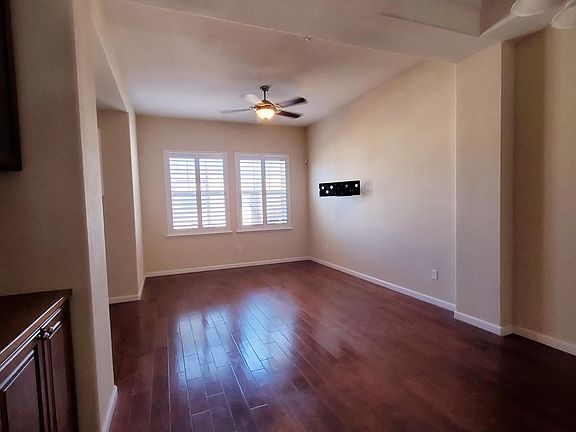 Living Area; wood flooring; full blinds; remote controlled light and fan.
