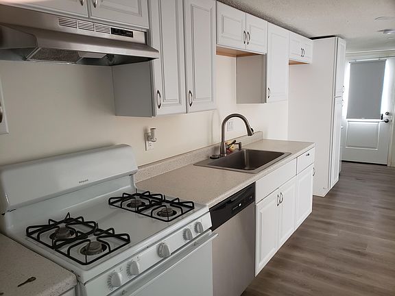 Newly updated kitchen with gas stove, new refrigerator and washer & dryer.