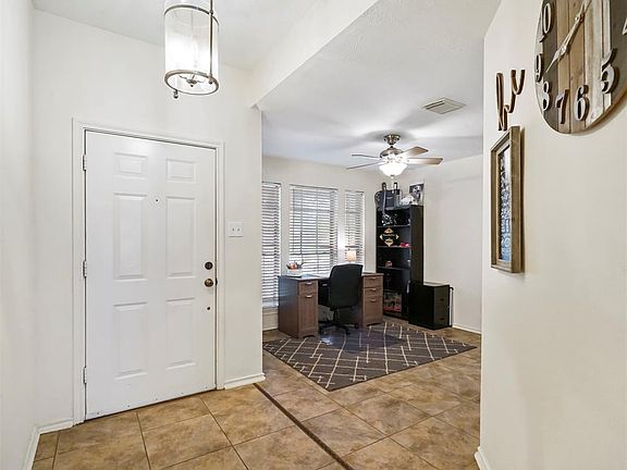 Enter your home through this formal entry way with your formal office off to your left.